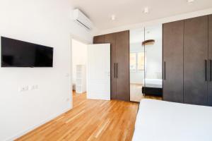 a bedroom with a bed and a tv on a wall at Casanuova in Rome