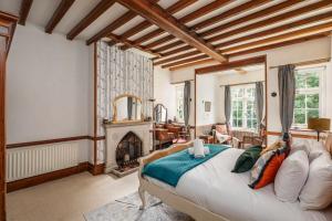 a bedroom with a large bed and a fireplace at To The Manor Born, cinema, pool table, hot tub in Poole +76 photos