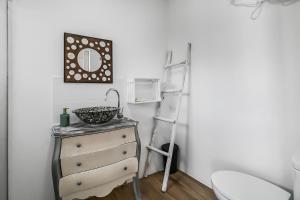 a bathroom with a sink and a ladder next to a dresser at Casa Bonita Peaceful Home in Ingenio +21 photos