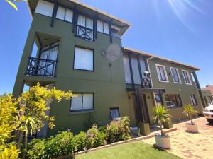 a green house with plants in front of it at Mayana - Holiday & Remote Work Beach Villa with Pool in Cape Town