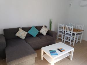 a living room with a couch and a table at Oasis Duna - Casa Mariposa in Corralejo +31 photos