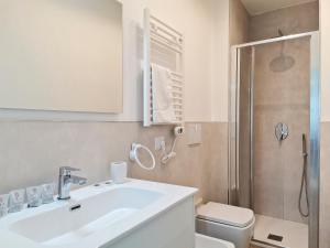 a bathroom with a sink and a toilet and a shower at VerdeMare Big House in Torre a Mare