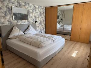 a bedroom with a large bed and a mirror at Bergmannsruh OG in Clausthal-Zellerfeld