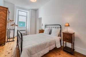 a bedroom with a large bed and a window at Villa Montcalm in Ax-les-Thermes