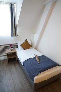 Postel nebo postele na pokoji v ubytování Centra Hotel Winterthur