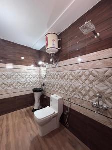 a bathroom with a toilet and a basketball hoop at Noorani Hills Home Stay 2 BHK in Patta