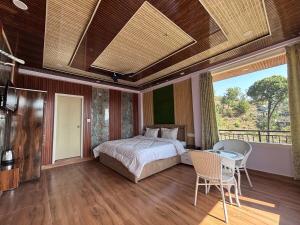 a bedroom with a bed and a table and chairs at Noorani Hills Home Stay 2 BHK in Patta