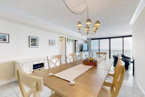 a dining room and living room with a table and chairs at Sea Colony - 1505N Edgewater House in Bethany Beach