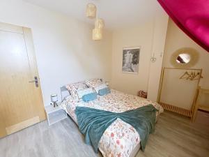 a bedroom with a bed and a purple ceiling at La Maison des Hirondelles in Lachelle