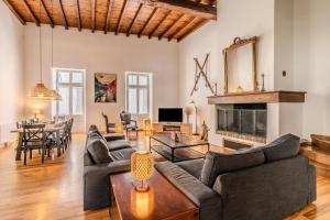 a living room with a couch and a table at Vila Marisa in Ax-les-Thermes