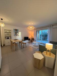 a living room with a couch and a table at RIVIERA COTTAGE in Mandelieu-La Napoule
