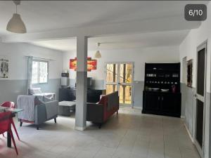 a living room with a couch and a table at Villa mango in Somone +1 photo