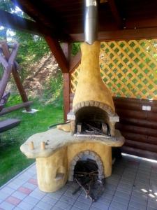 an outdoor pizza oven sitting on a patio at Trend Hotel in Námestovo