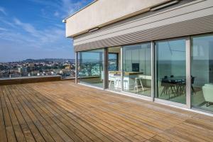 チヴィタノーヴァ・マルケにあるTra sole e luna - Civitanova, appartamento nobiliare fronte mareの建物内のデッキ(テーブル、椅子付)