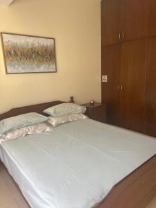 a bedroom with a large bed with white sheets at Tranquil paradise in Larnaca +10 photos