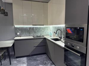 a kitchen with a sink and a microwave at Crystal Apartments in Tbilisi City