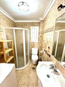 a bathroom with a shower and a toilet and a sink at Apartamento a pie de playa en El Portil in El Portil