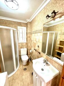 a bathroom with a sink and a toilet and a shower at Apartamento a pie de playa en El Portil in El Portil +15 photos
