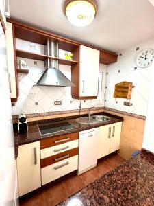 a kitchen with a sink and a stove at Apartamento a pie de playa en El Portil in El Portil