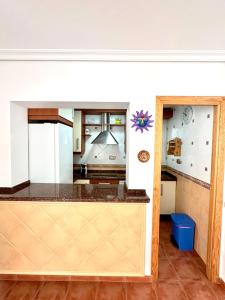 a kitchen with a counter top in a room at Apartamento a pie de playa en El Portil in El Portil