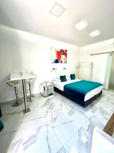 a bedroom with a bed and a table and a sink at Apartments Lomara in Dubrovnik