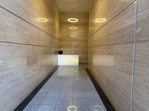 a hallway of a building with a wooden wall at Crystal Apartments in Tbilisi City +11 photos