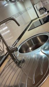 a stainless steel sink on top of a machine at La Paserina in Arenas de Cabrales +17 photos