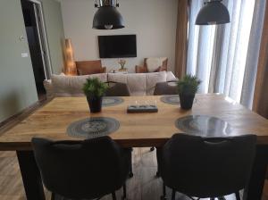 a living room with a wooden table and chairs at Aan't Strand Bed by the Sea Adults only in Westkapelle