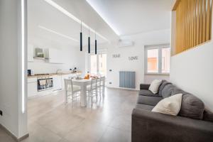 a living room and kitchen with a couch and a table at Sole Apartments in Terracina
