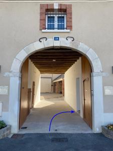 an entrance to a building with an archway at Maison Marguerite in Chouilly