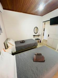 een slaapkamer met een bed en een groot tapijt bij Dada's Cottage in Argyrádes