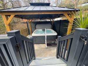 a gazebo with a hot tub in it at Aberdunant Hall in Porthmadog
