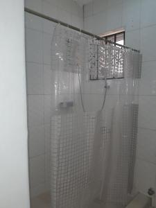 a shower in a bathroom with a shower curtain at a home away from home in Trofwi