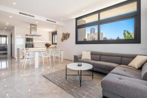 a living room with a couch and a table at Sunset Waves IV by Terreta Rentals in Benidorm