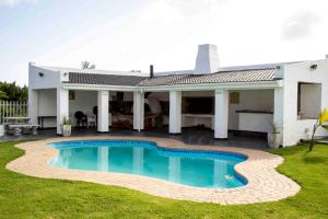 a house with a swimming pool in the yard at Victoria Heights B&B in George