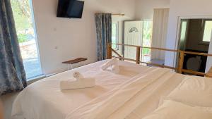 a bedroom with a bed with two white boxes on it at Rida Village Ksamil Island in Ksamil