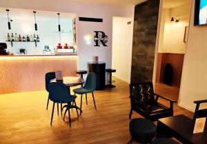 a room with a table and chairs and a bar at Residencial Douro in Peso da Régua