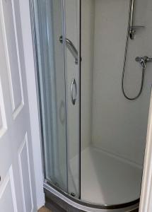 a shower stall with a glass shower door at 3 Telford Mews in Dumfries