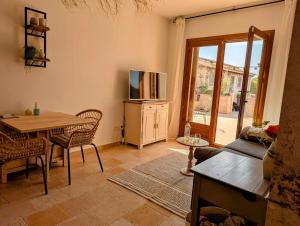 a living room with a table and a tv at Villa Oasis in Vera