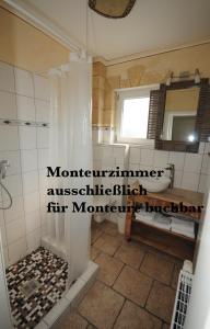 a bathroom with a shower and a tub and a sink at Seehotel Europa in Schwanau