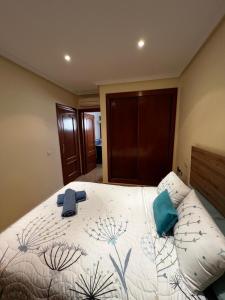 a bedroom with a bed with two towels on it at Spectacular Flat Vera Playa in Playas de Vera