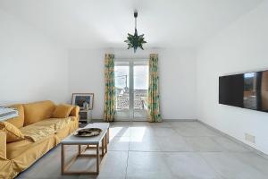 Una sala de estar con un sofá y un televisor. en Spacious cocoon in Narbonne - with sea view, en Narbona