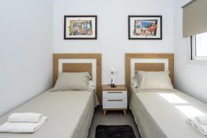 Postel nebo postele na pokoji v ubytování Eslanzarote Aptos Mozaga Nice by Corujo