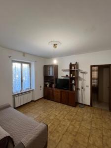 Un dormitorio con una cama y un televisor. en Casa dell'Orto, en La Spezia