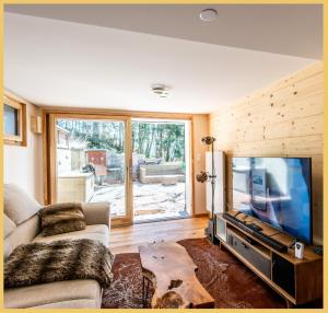 Televisyen dan/atau pusat hiburan di Chalet I Sous le Bois