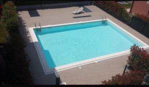 an overhead view of a swimming pool with a chair at Casa Miranda in Caronno Pertusella