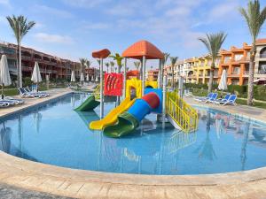 a pool with a water slide in a resort at Porto Matrouh Unique Chalet 73004 in Marsa Matruh