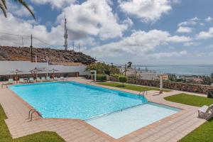 a swimming pool with a view of the ocean at Confortable Bungalow With Views in San Bartolomé de Tirajana