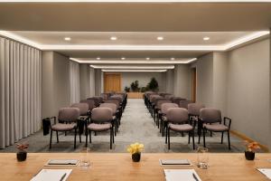 a conference room with a row of chairs and tables at Dom Jose Beach Hotel (Plus) in Quarteira +37 photos