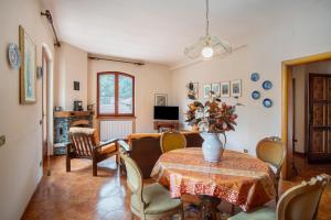 a dining room with a table with a vase on it at Casa Lilli in Pieve di Teco